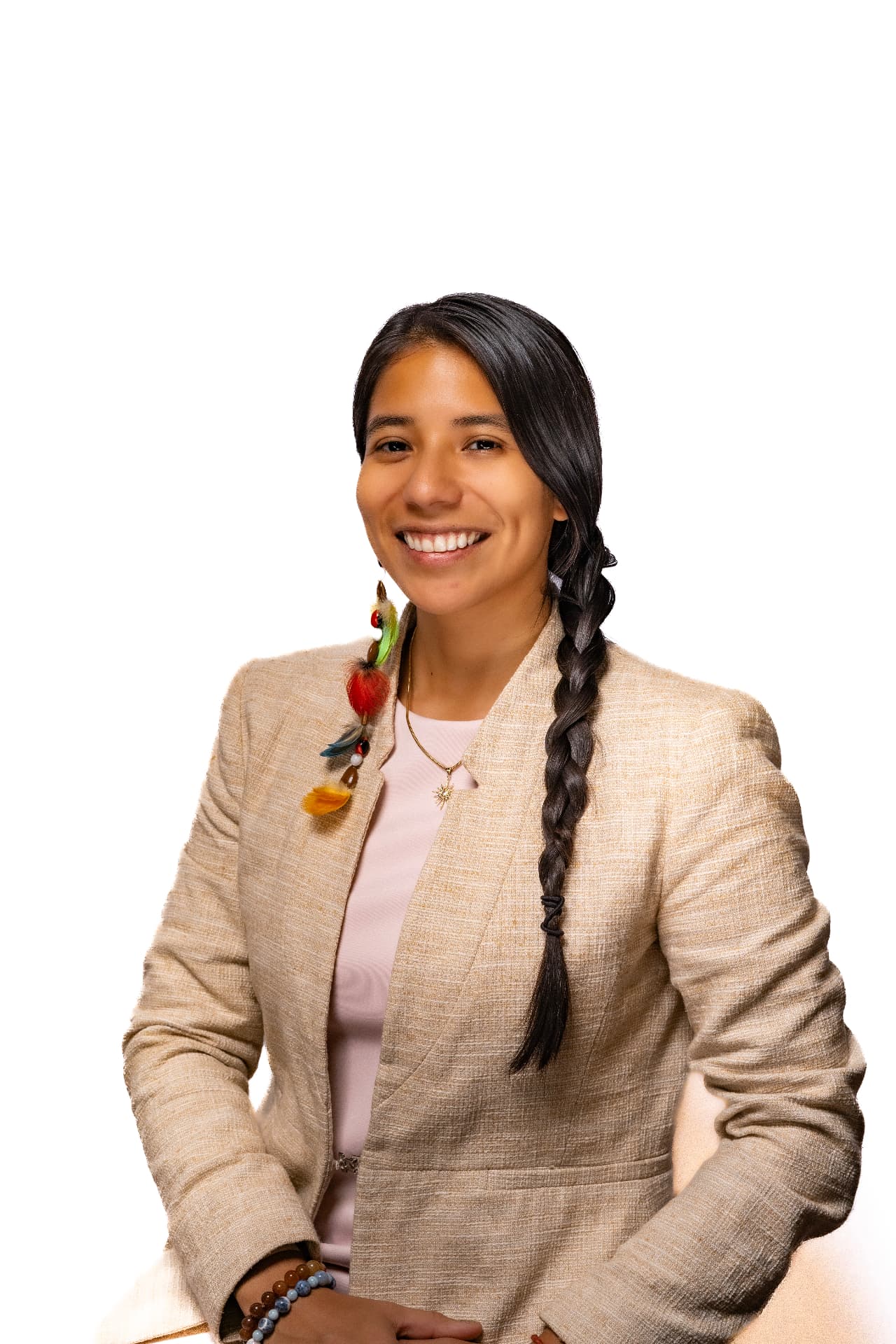 Yura Sapi in a professional portrait against a white background, wearing a light blazer