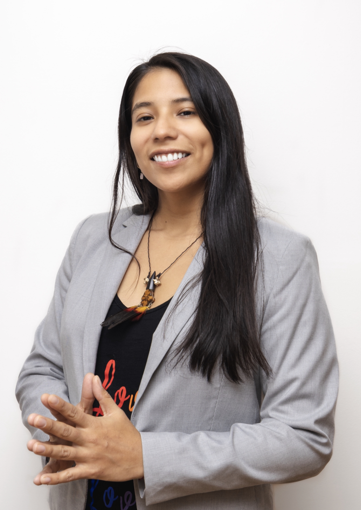 Yura Sapi in a professional portrait wearing a light-gray blazer